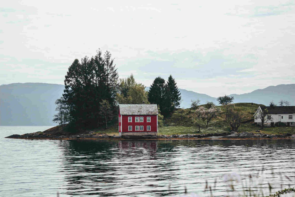 Red house on small island in the middle of a lake PIT UK Home